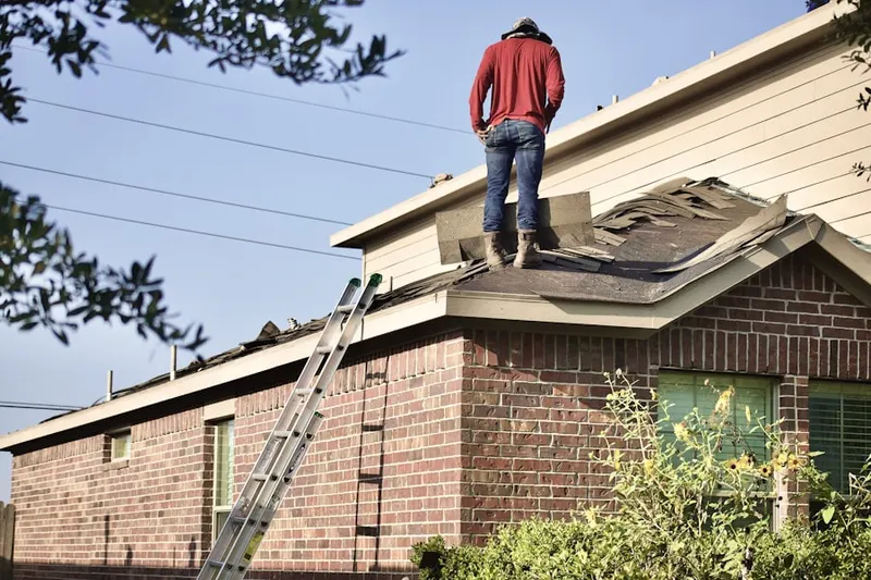 Professional roofer working on a residential roof in Mc Cormick Farm